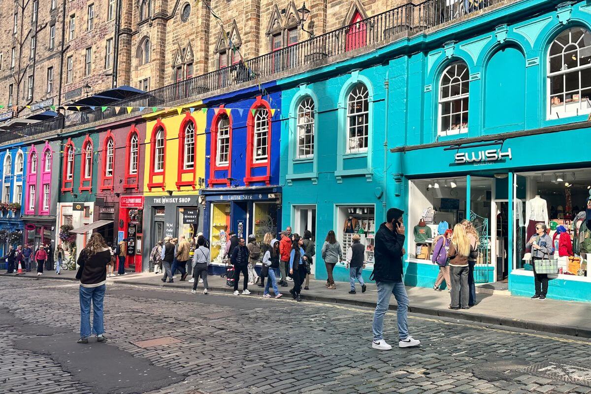 Farbenfrohe Victoria Street in Edinburgh mit Geschäften und Touristen